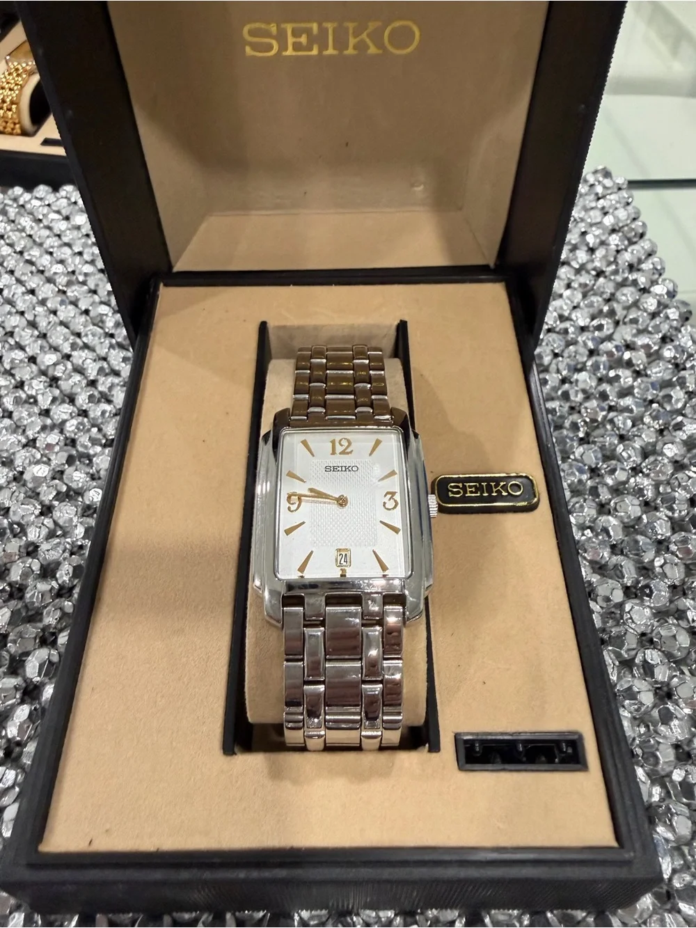 Seiko Silver Watch with Gold Accents and Rectangular Dial